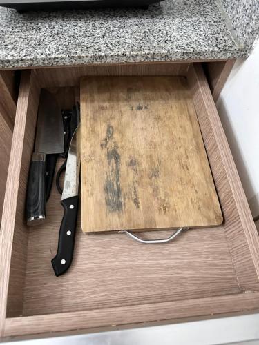 a drawer with a cutting board and a knife at Arezzo Condo Staycation in Davao City