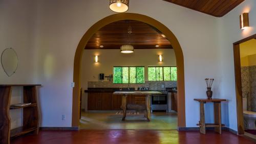 an archway in a kitchen with a table at Terra Coral - Chapada dos Veadeiros in Alto Paraíso de Goiás