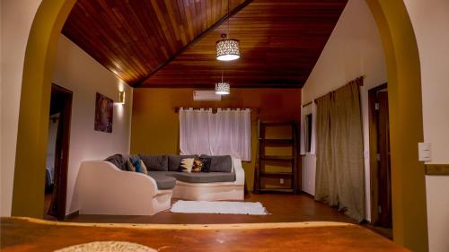 a living room with a couch and a window at Terra Coral - Chapada dos Veadeiros in Alto Paraíso de Goiás