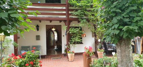 a house with potted plants on the front of it at Hoffmanns-Hof-Sinspert in Reichshof 