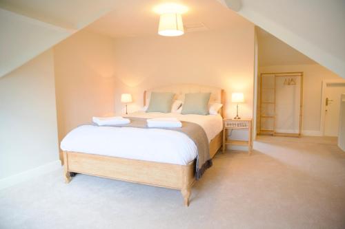 a bedroom with a large bed with two pillows at Bridgnorth Town House in Bridgnorth