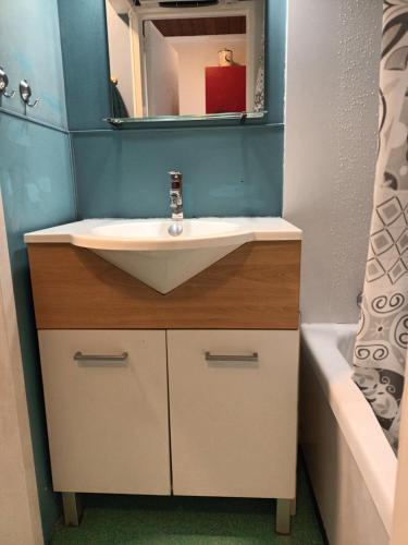 a bathroom with a sink and a mirror at Au repos de Zoé in Waulsort