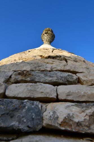 a statue on top of a stone wall at Trulli di Titti - Luxury Country House in Castellana Grotte