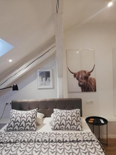 a bedroom with a bed and a picture of a bull on the wall at Apartments Simple Teslina in Zagreb