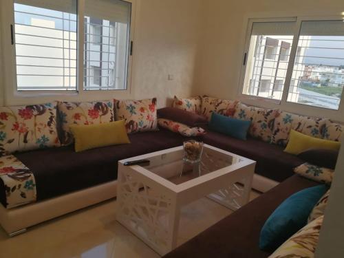 a living room with a couch and a coffee table at Appartement meublé Unica 2 Fes in Fez