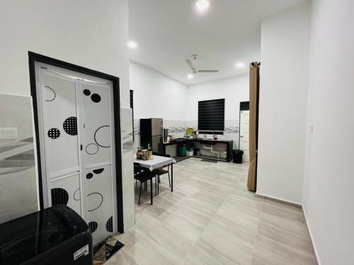 a living room with a room with a table and a television at Syakila Homestay in Marang