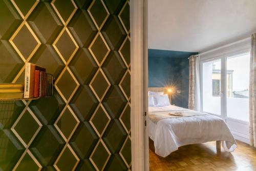 - une chambre avec un mur vert, un lit et une fenêtre dans l'établissement Mc Guigan's appart hôtel appartement, à Brest