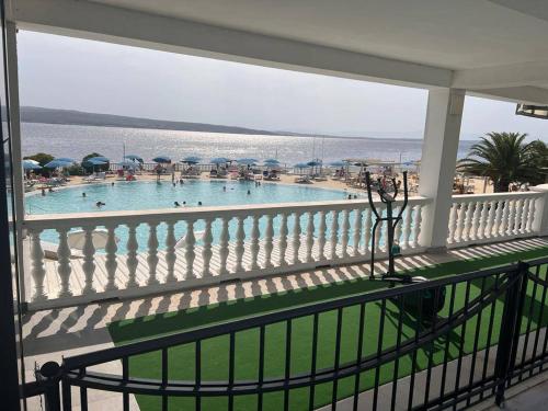 a balcony with a view of a swimming pool at Hotel Millenium deluxe in Selce