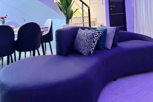 a purple couch with pillows on top of it at Luxury Shortlet Apartment LBS, AJAH in Lagos