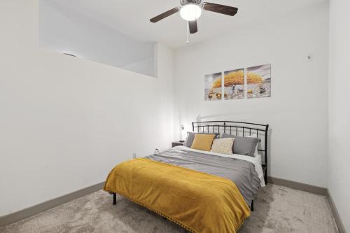 a bedroom with a bed with a ceiling fan at Stylish 1 Bedroom Apartment in Medical District in Dallas