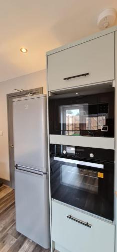 a kitchen with a white refrigerator and an oven at Enchanting Escape Castle Vale in Minworth