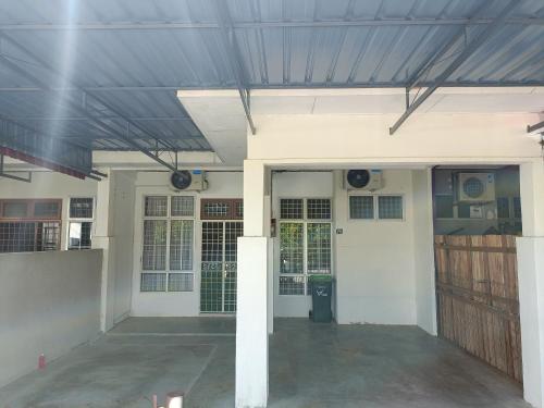 an empty garage with a blue roof on a house at Adempuri Homestay 3 in Jitra