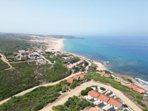 an aerial view of a beach with houses and the ocean at Villetta Albachiara in Sant' Antonio di Santadi