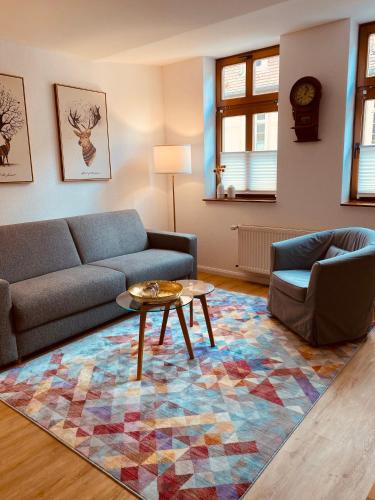a living room with a couch and a table at AltstadtQuartier Burg in Burg bei Magdeburg