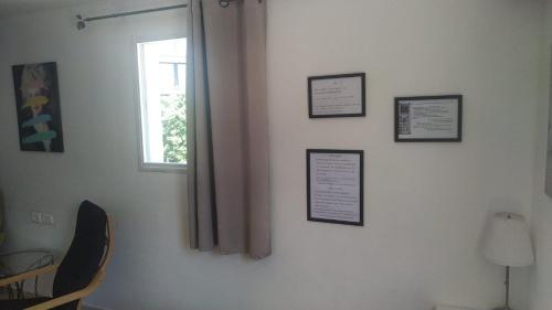 a room with a window and pictures on the wall at Amir's Apartments in Tel Aviv