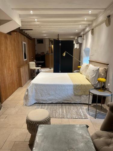 a bedroom with a large bed and a living room at TheRoom in Šibenik