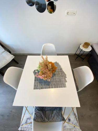 a white table and chairs in a living room at Home Mia Airport in Podgorica