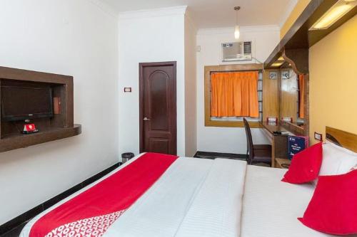 een slaapkamer met een groot bed en een rode deken bij Hotel Sunpark Inn in Chennai