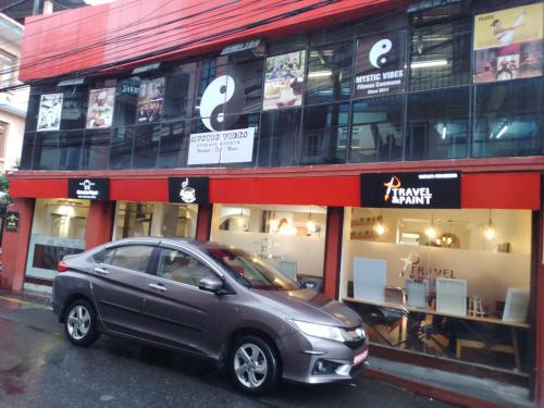 a small car parked in front of a store at Mystic Vibes Fitness Homestay Commune in Kathmandu