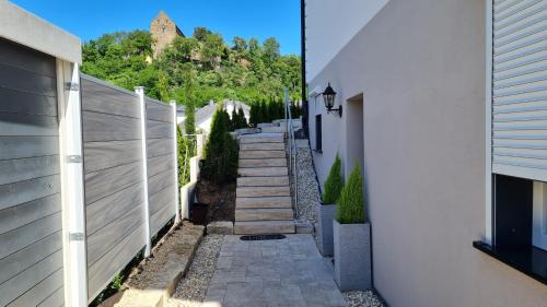 a stairway between two buildings with a fence at Villa unter dem Schloss in Cleebronn