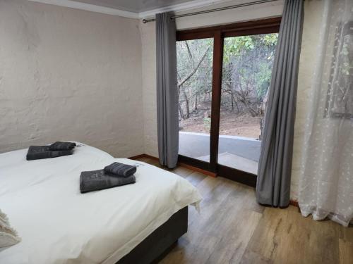 Uma cama ou camas num quarto em Boomhuis, Mabalingwe