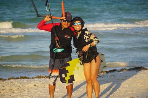 a man and woman standing on the beach at Casa Omero Seaview. in El Cuyo