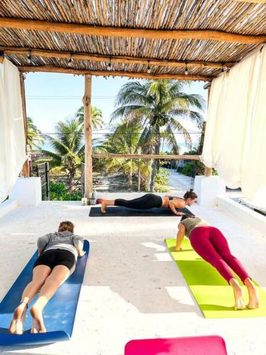 a group of people doing yoga on mats at Casa Omero Seaview. in El Cuyo