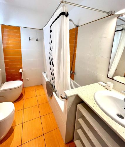 a bathroom with a toilet and a sink at Villa Binibaquet in Binibeca