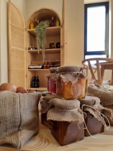 a room with a table with several jars of honey at Thymises Boutique Hotel in Kakopetria