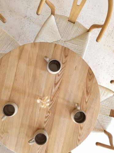 a wooden table with three cups on top of it at Thymises Boutique Hotel in Kakopetria