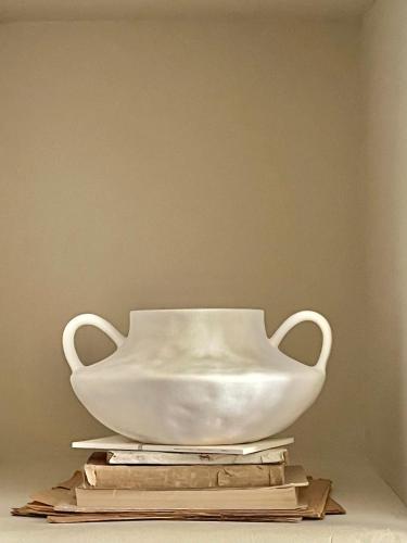 a white bowl sitting on top of a stack of books at Thymises Boutique Hotel in Kakopetria