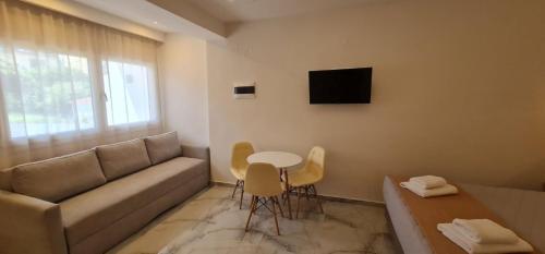 a living room with a couch and a table at Z Elegant Studios in Perea