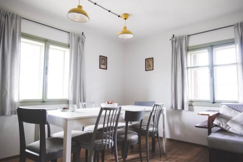 a dining room with a white table and chairs at Chaloupka Na Gruni in Hrádek