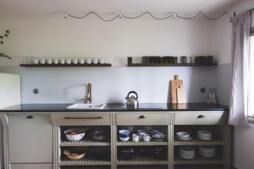 a kitchen with a sink and a counter top at Chaloupka Na Gruni in Hrádek