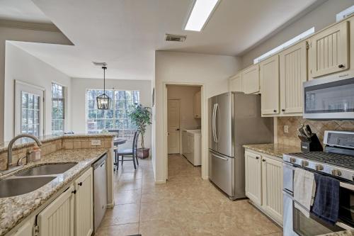a kitchen with a sink and a refrigerator at New! Pool, Spa, Nature Trails - The Woodlands 4BR Forest Retreat! in Spring