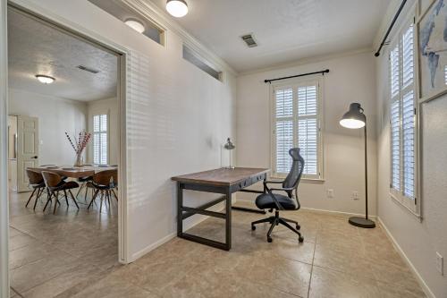 a home office with a desk and a table at New! Pool, Spa, Nature Trails - The Woodlands 4BR Forest Retreat! in Spring