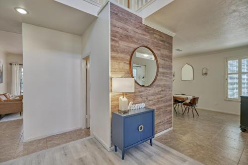a living room with a blue table and a mirror at New! Pool, Spa, Nature Trails - The Woodlands 4BR Forest Retreat! in Spring