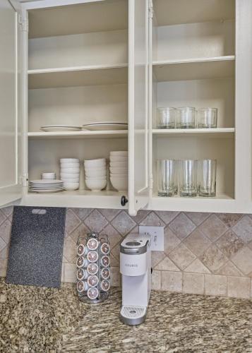 a kitchen cabinet with plates and dishes in it at New! Pool, Spa, Nature Trails - The Woodlands 4BR Forest Retreat! in Spring
