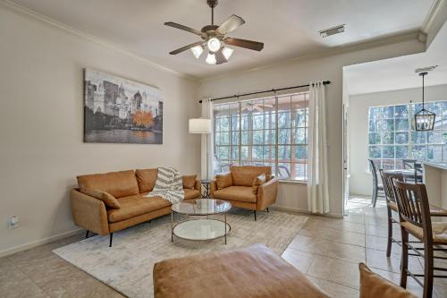 a living room with a couch and a table at New! Pool, Spa, Nature Trails - The Woodlands 4BR Forest Retreat! in Spring
