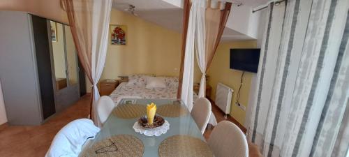a room with a table and chairs and a bed at Apartments Villa Bella Vista Hvar in Hvar