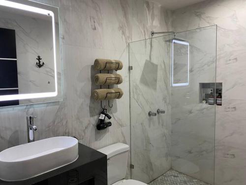a bathroom with a shower and a toilet and a sink at Urban Hotel Ancla Suite 10 - 3 Bedroom 2 Bathroom in Puerto Peñasco