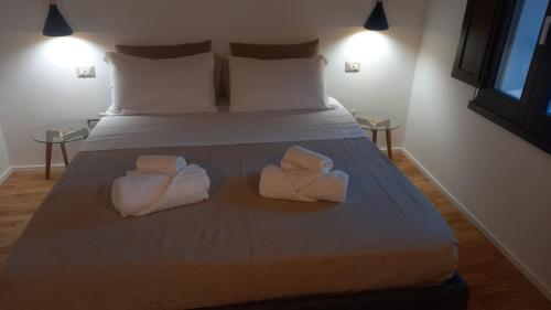 a bedroom with a bed with towels on it at La casetta Guest House Oristano in Oristano