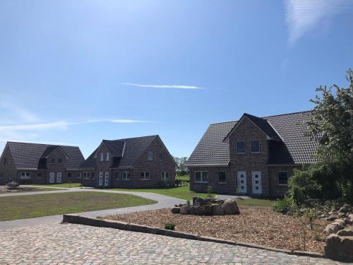 a row of brick houses with a driveway at Ferienhof-Micheel in Gammendorf