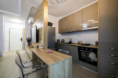a kitchen with a wooden counter top in a room at Purple Luxury Apartment Lake On in Mamaia