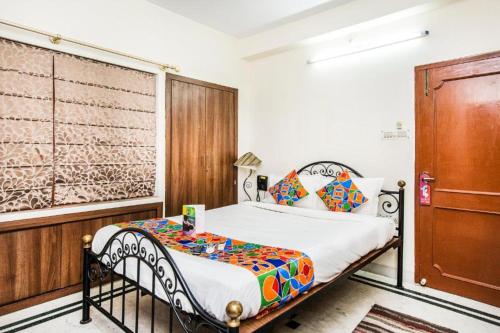 sypialnia z łóżkiem i drewnianymi drzwiami w obiekcie Hotel Ullash Residency Salt Lake Kolkata w mieście Salt Lake City