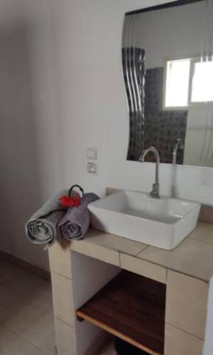 a bathroom with a sink and a mirror at Résidence Riziq villa 2 in Nosy Be