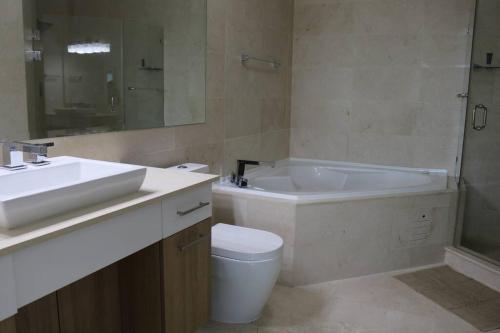 a bathroom with a sink and a tub and a toilet at 09B Perfect 1-bedroom apartment with stunning view in ArraijÃ¡n