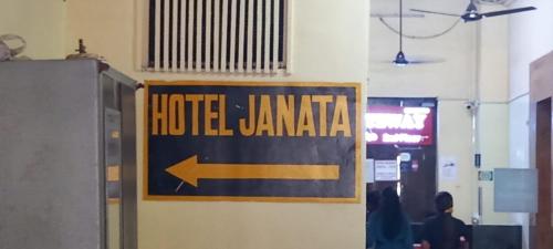 a sign for the hotel jamaica on a wall at Hotel Janata in Mumbai