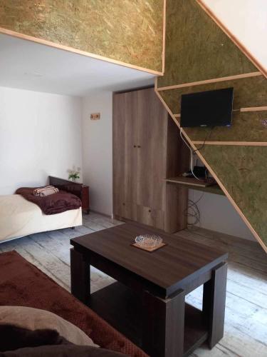 a room with a bed and a table in a room at Eli’s home in Borjomi