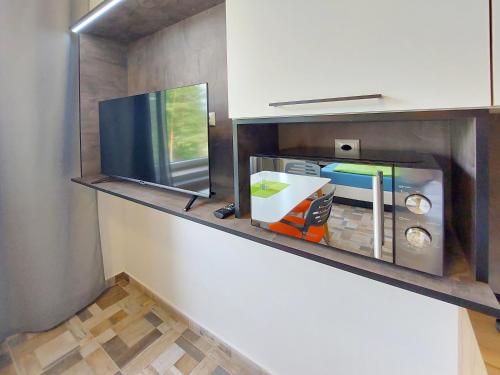 a room with a tv on a shelf at Wesendorf Residenz Premium Lounge in Wesendorf
